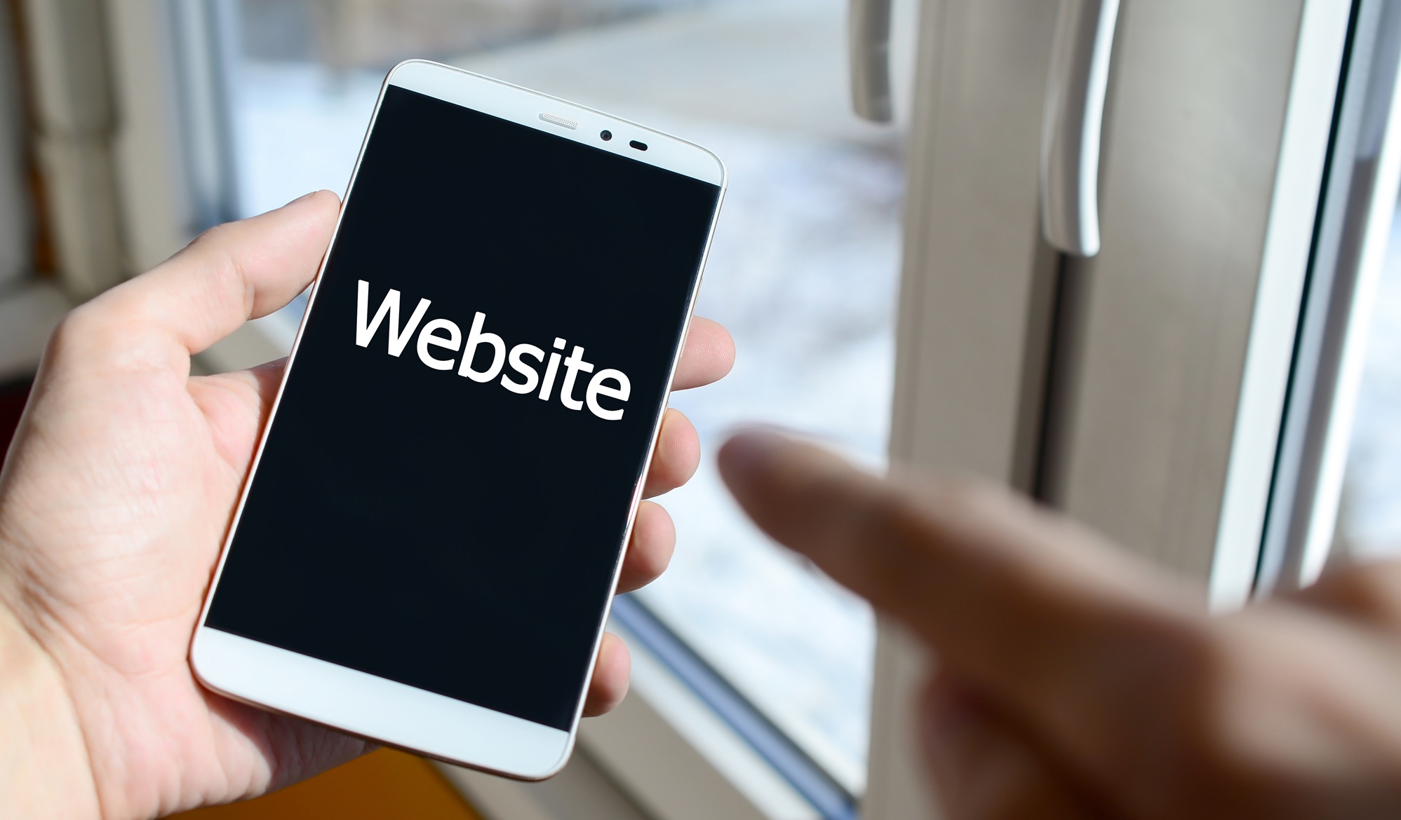 A person sees a white inscription on a black smartphone display Website policies